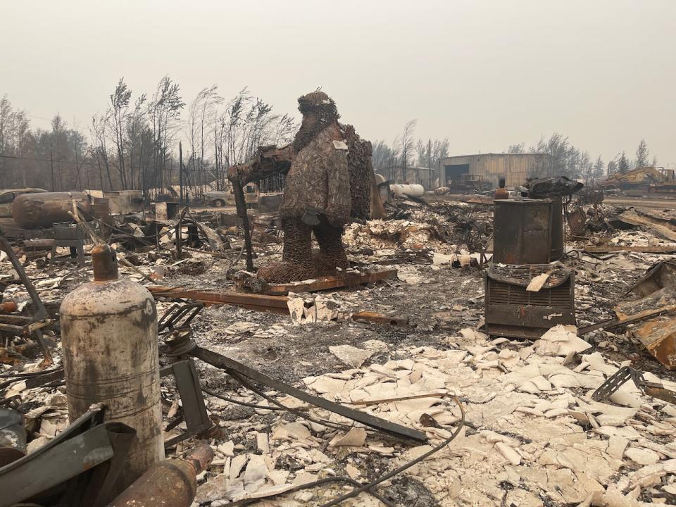 Dolphus Cadieux's statue of a trapper stand among the rubble and ash that's left of Enterprise. 