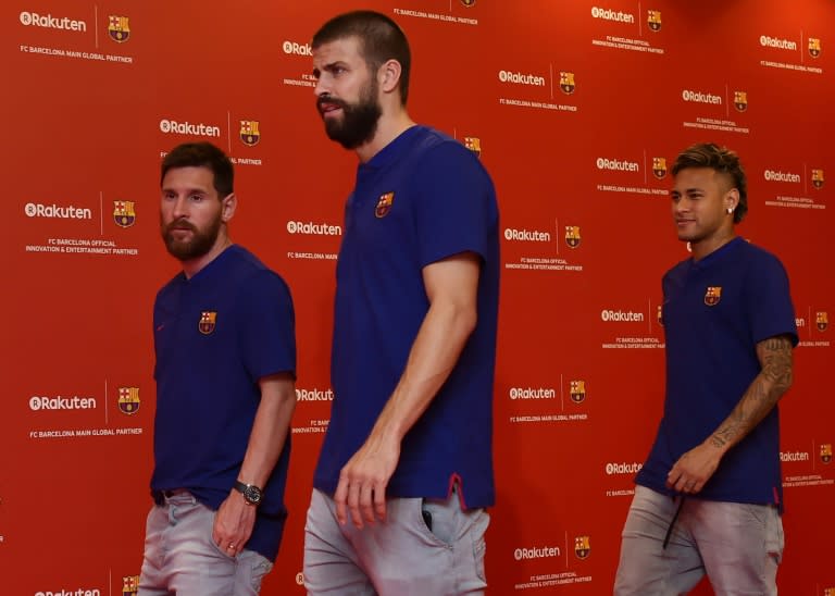 (From L) Barcelona players Lionel Messi, Gerard Pique, and Neymar arrive at a team event in Tokyo on July 13, 2017, following a press conference to announce new sponsorship with Japanese internet retailer Rakuten