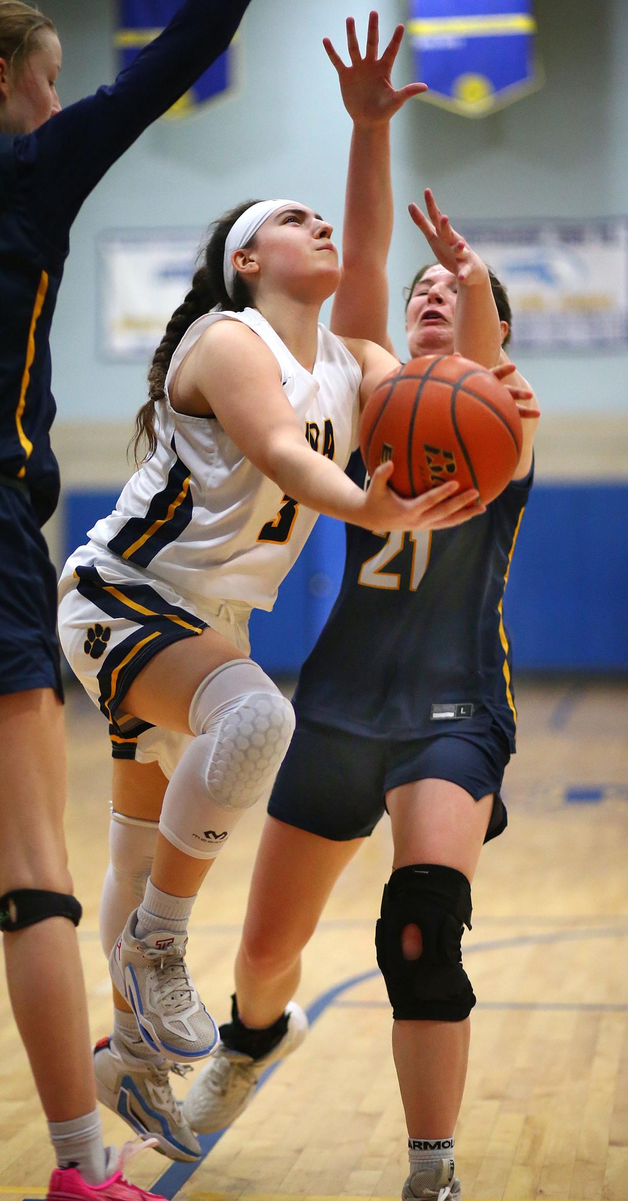 Elle Orlando lays up a shot and draws a foul from Fontbonne #21 Jess Leflamme.
Notre Dame Hingham hosts Fontbonne Academy Milton in girls basketball on Friday Jan. 12, 2024