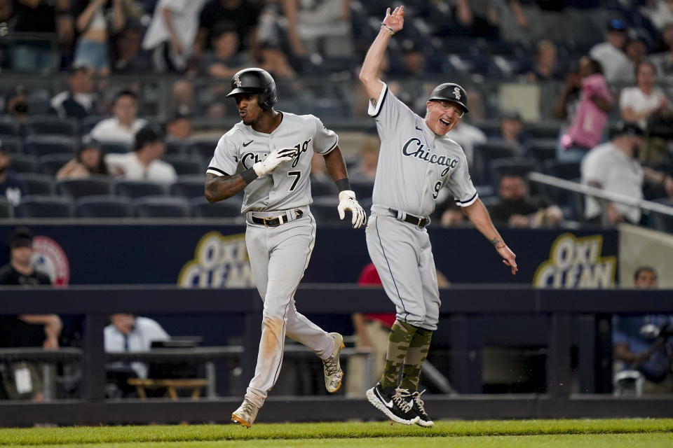Chicago White Sox' Tim Anderson (7) celebrates with third base coach Joe McEwing (99) while running the bases after hitting a three-run home run off New York Yankees relief pitcher Miguel Castro in the eighth inning of the second baseball game of a doubleheader, Sunday, May 22, 2022, in New York. (AP Photo/John Minchillo)
