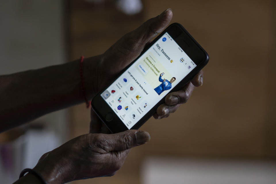 A woman shows her account at policybazaar app on her phone in Mumbai, India, Wednesday, Aug. 10, 2022. A cybersecurity firm told the major Indian online insurance brokerage last month that critical vulnerabilities in the company’s internet-facing network could expose sensitive personal and financial data from its 11 million customers. CyberX9 followed the standard ethical-hacker playbook, giving the brokerage time to patch the flaws and inform authorities. A week later, publicly traded Policybazaar said it had been illegally breached but “no significant customer data was exposed.” (AP Photo/Rafiq Maqbool)