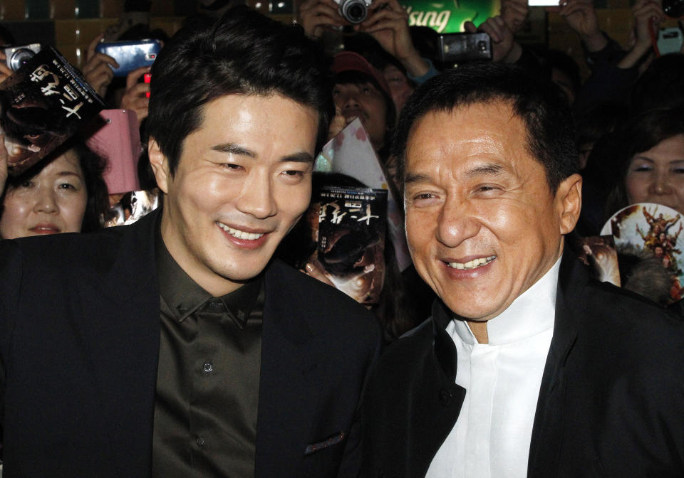 CORRECTS YEAR - Hong Kong actor and director Jackie Chan, right, and South Korean actor Kwon Sang-woo smile during a promotional event for their latest movie, CZ12, or Chinese Zodiac, in Seoul, South Korea, Monday, Feb. 18, 2013.(AP Photo/Ahn Young-joon)