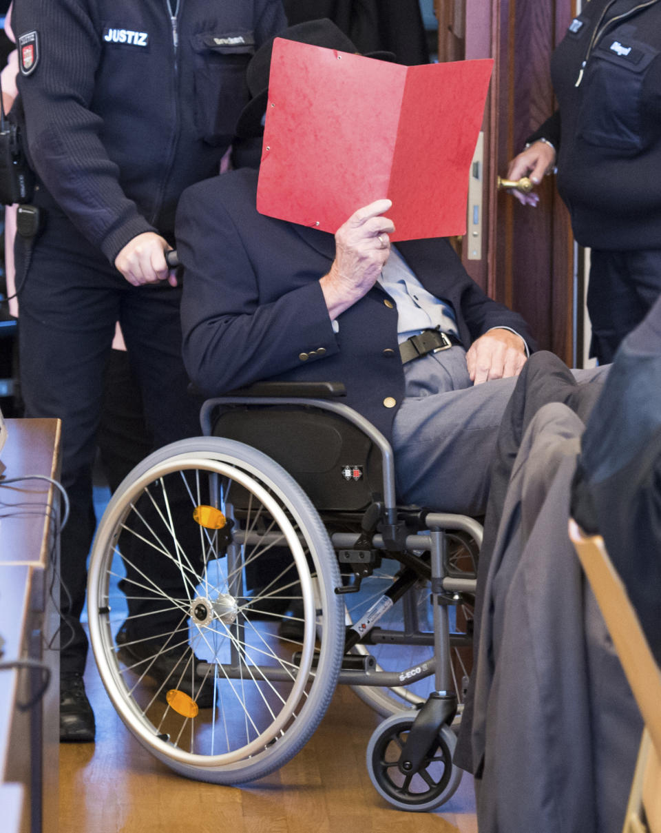 93-year-old former SS guard Bruno Dey in the concentration camp Stutthof near Danzig is sitting in the regional court in Hamburg, Germany, Oct.17, 2019. The prosecution accuses the 93-year-old man of aiding and abetting the murder of 5230 people. The defendant was only 17 or 18 years old at the time of the crime. That's why the trial takes place in front of a juvenile delinquency chamber. About 25 survivors of the concentration camp appear as joint plaintiffs. (Daniel Bockwoldt/dpa via AP)