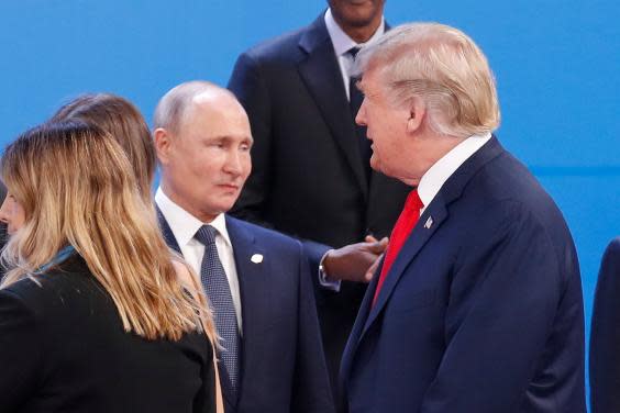 President Donald Trump and Russia's President Vladimir Putin as they gather for a group photo at the start of the G20 summit, Buenos Aires, Argentina. 30 November 2018. (AP Photo/Pablo Martinez Monsivais, File)