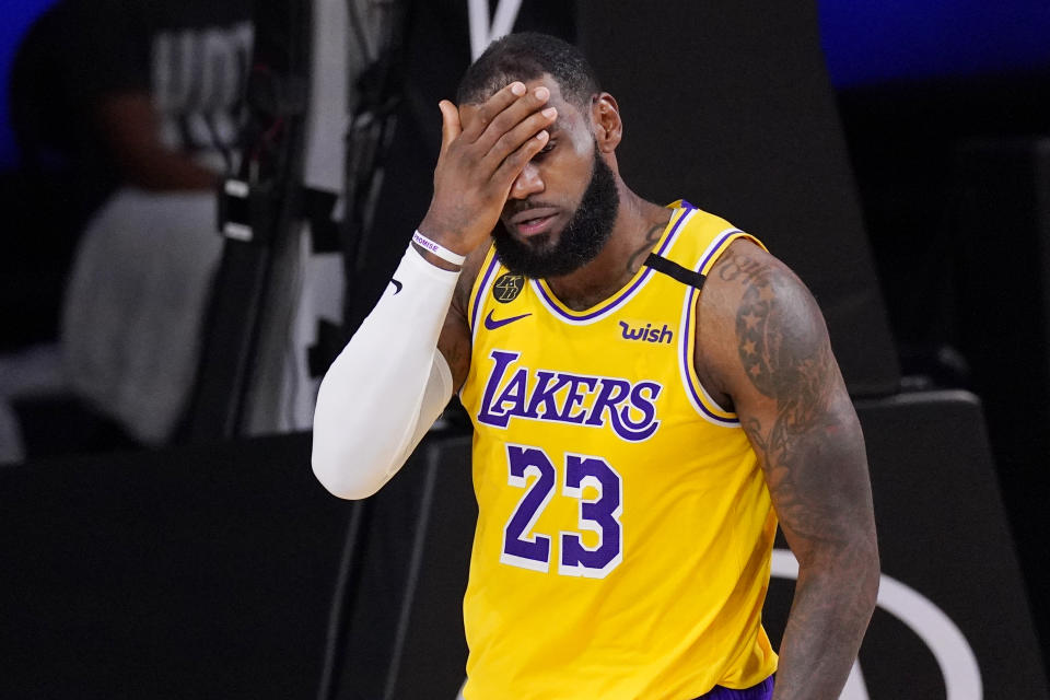 Los Angeles Lakers' LeBron James wipes his face after being fouled during the second half of an NBA conference final playoff basketball game against the Denver Nuggets Thursday, Sept. 24, 2020, in Lake Buena Vista, Fla. The Lakers won 114-108. (AP Photo/Mark J. Terrill)