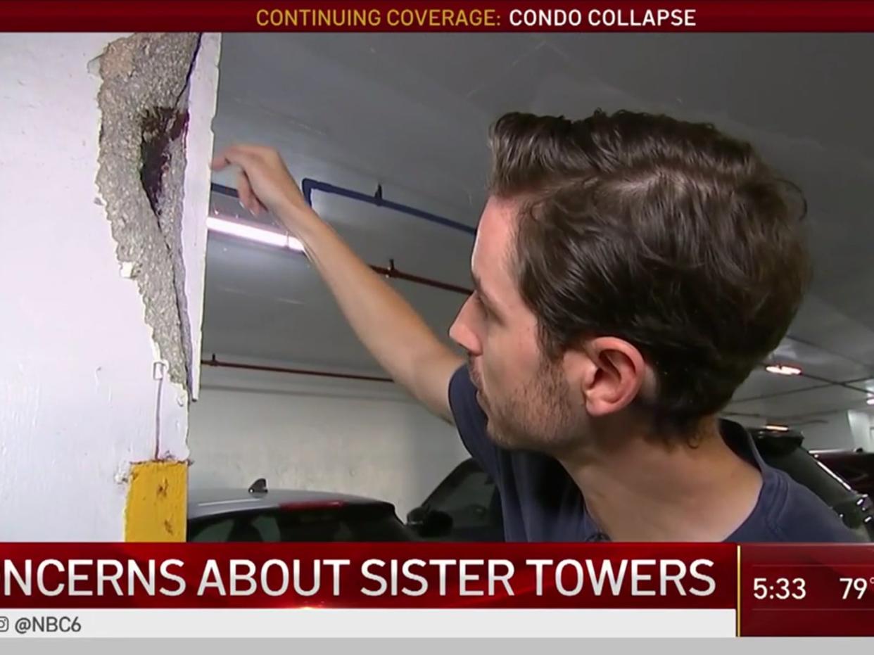 A resident of a sister building to Champlain Towers South points to a crack in his block (NBC News Miami)