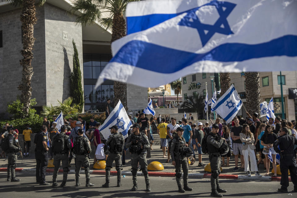 Israeli paramilitary border police officers stand guard as Jewish right-wing demonstrators demand the release of three Jews arrested in the shooting death of Mousa Hasoona, outside the District Court in Lod, Israel, Wednesday, May 12, 2021. Police say Hasoona was with a group of Arab rioters threatening Jewish homes, an account disputed by Lod's Arab residents. (AP Photo/Heidi Levine)