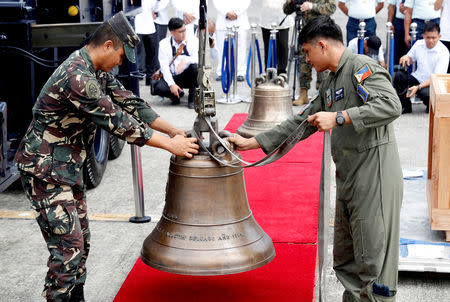 Philippine Air Force personnel unload the bells of Balangiga after their arrival at Villamor Air Base in Pasay, Metro Manila, Philippines December 11, 2018. REUTERS/Erik De Castro