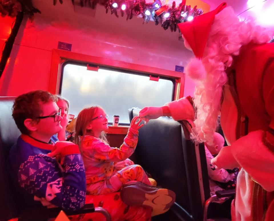 Santa Claus visits Gabe McDonnell, 15, Kyla McDonnell, 6, and Brenna McDonnell, 12 — the children of The Oklahoman Features Writer Brandy McDonnell — on Oklahoma City's "The Polar Express Train Ride," produced by Rail Events Productions, Saturday, Nov. 19, 2022. Based on the beloved book and movie, the rides continue through Dec. 27 at the Oklahoma Railway Museum in Oklahoma City.