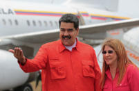 Venezuela's President Nicolas Maduro and his wife Cilia Flores smile upon their arrival at a campaign rally in Ciudad Guayana, Venezuela April 23, 2018. Miraflores Palace/Handout via REUTERS