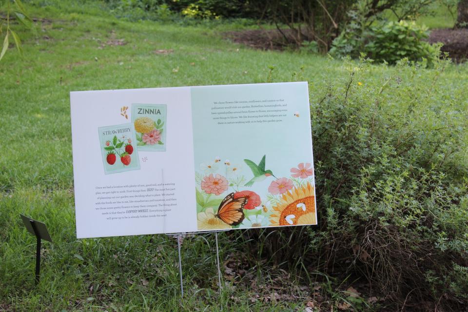 The family StoryWalk features the book “We are the Gardeners” by Joanna Gaines.