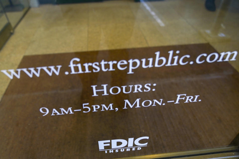 The hours of operation and the FDIC Insured status is on display at the front door of a First Republic Bank in the Financial District of Manhattan, Thursday, March 16, 2023. The S&P 500 was 0.8% higher in midday trading after erasing an earlier loss of nearly that much following reports that First Republic Bank could receive financial assistance or sell itself to another bank. (AP Photo/Mary Altaffer)