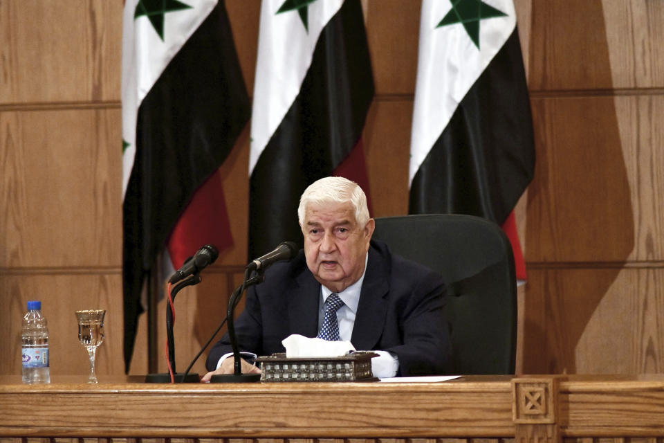 In this photo released by the Syrian official news agency SANA, Syrian Foreign Minister Walid al-Moallem speaks during a news conference, in Damascus, Syria, Tuesday, June 23, 2020. Walid al-Moallem accused the United States on Tuesday of allegedly "seeking to starve the people" of Syria by imposing new sanctions and opening the door for "terrorism" to return to the war-torn country. (SANA via AP)