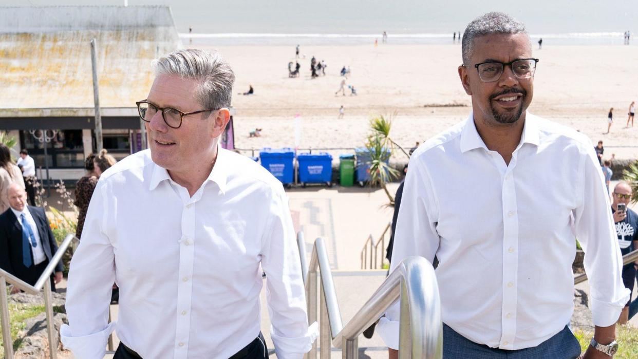 Keir Starmer on the left walking alongside Vaughan Gething (right)