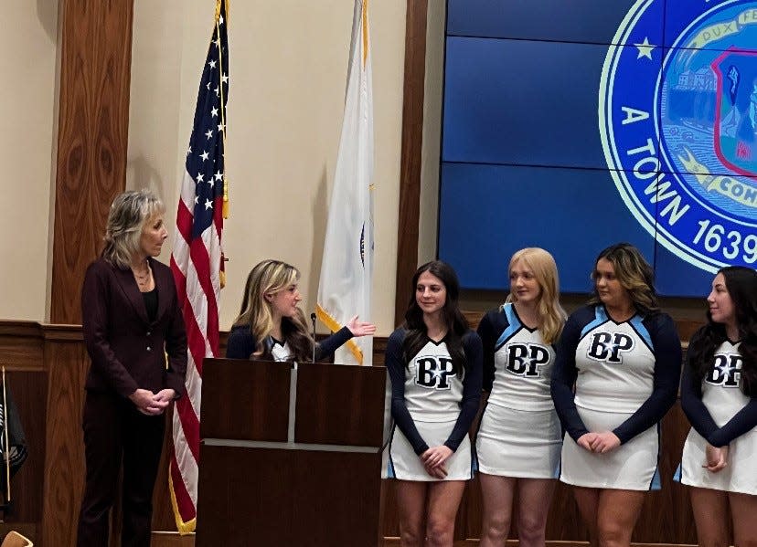 Bristol-Plymouth Regional Technical School cheerleader team co-captain Mya Pereira expresses her team's appreciation to Mayor Shaunna O'Connell, left, and the City Council for presenting them with congratulatory citations on Nov. 29, 2022.