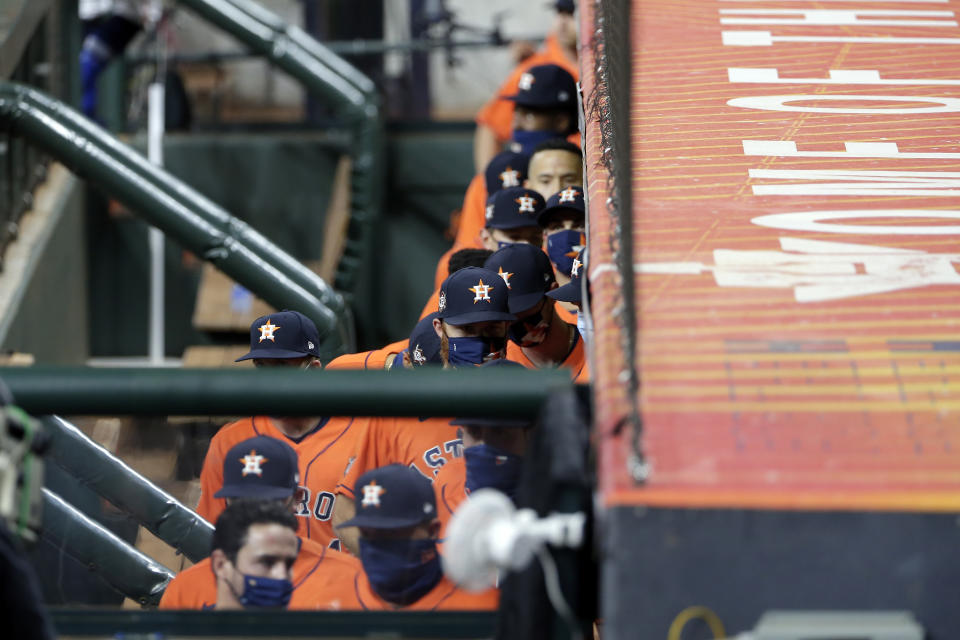 Houston Astros players leave the dugout as they walk out in protest of racial injustice before their baseball game against the Oakland Athletics, Friday, Aug. 28, 2020, in Houston. (AP Photo/Michael Wyke)