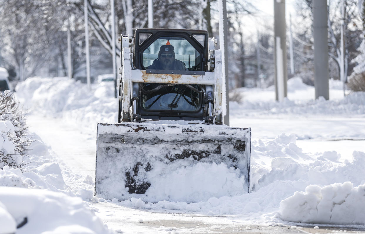 Snow is cleared from a walkway.