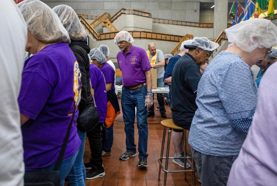 Ronald Coleman, 80, a past district governor for the Lions Club International, walks behind other Lions Club International members inside the Wayne County Community College in Detroit on Saturday, June 10, 2023. Coleman was a district governor from 1998 to 1999.