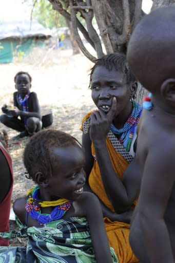 A handout picture released by the UN on January 5, shows internally displaced persons resting in Pibor, Jonglei state after fleeing the surrounding areas following a wave of bloody ethnic violence. Over 3,000 people were killed in South Sudan in brutal massacres last week in an explosion of ethnic violence, a local official said Friday as the UN increased patrols