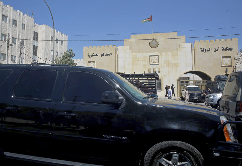 Bassem Awadallah, a former royal adviser, leaves a state security court in a vehicle after the first session of his trial, in Amman, Jordan, Monday, June. 21, 2021. Awadallah, who has Jordanian, U.S. and Saudi citizenship, and Sharif Hassan bin Zaid, a distant cousin of the king, pleaded not guilty Monday to sedition and incitement charges, a defense lawyer said. (AP Photo/Raad Adayleh)