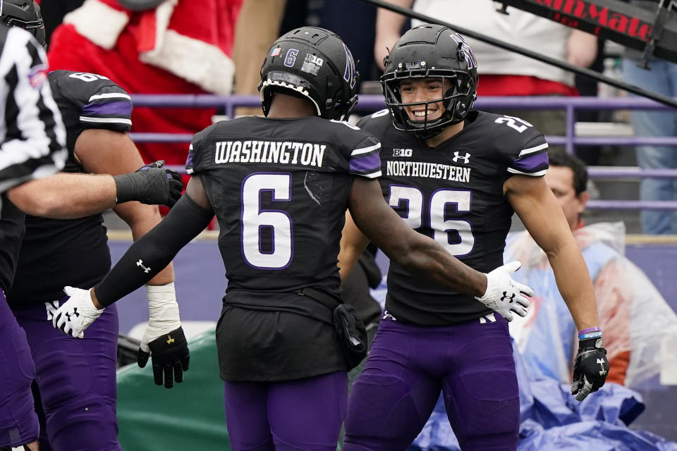 Northwestern running back Evan Hull, right, celebrates with wide receiver Malik Washington after scoring a his touchdown during the first half of an NCAA college football game against Ohio State, Saturday, Nov. 5, 2022, in Evanston, Ill. (AP Photo/Nam Y. Huh)