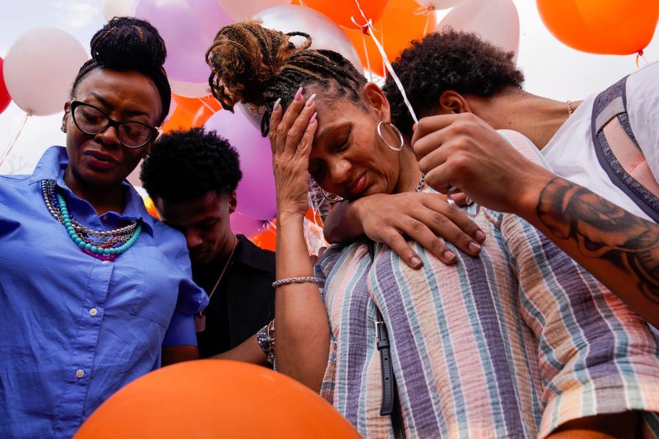 Khalil Amari Allen's mother, DeLisa Glaspie, center, becomes emotional while surrounded by friends and family during a vigil honoring Allen, 18, in Southfield on Friday, July 14, 2023. Allen was shot and killed while driving to get food the evening of July 11.