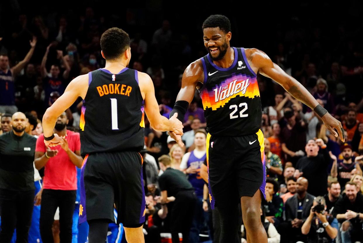 May 2, 2022; Phoenix, Arizona, USA; Phoenix Suns guard Devin Booker (1) and center Deandre Ayton (22) react after a fast-break basket against the Dallas Mavericks during game one of the second round for the 2022 NBA playoffs at Footprint Center.
