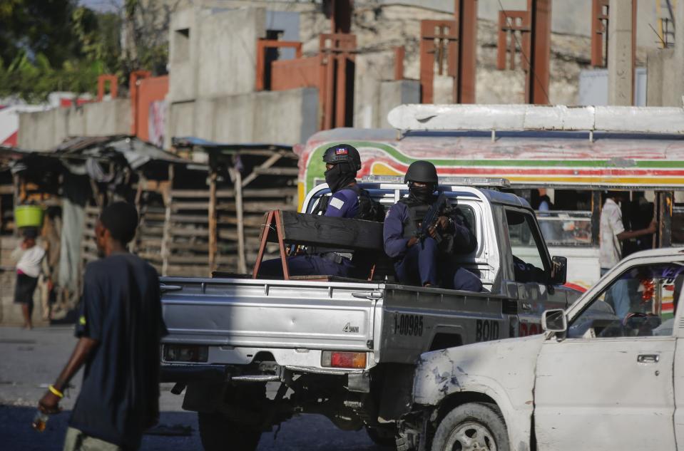 Police patrol through the streets of downtown Port-au-Prince, Haiti, Monday, Jan. 22, 2024. The Archdiocese of Port-au-Prince is pleading for the release of six nuns kidnapped last week and demanding that Haiti's government crack down on gang violence. (AP Photo/Odelyn Joseph)