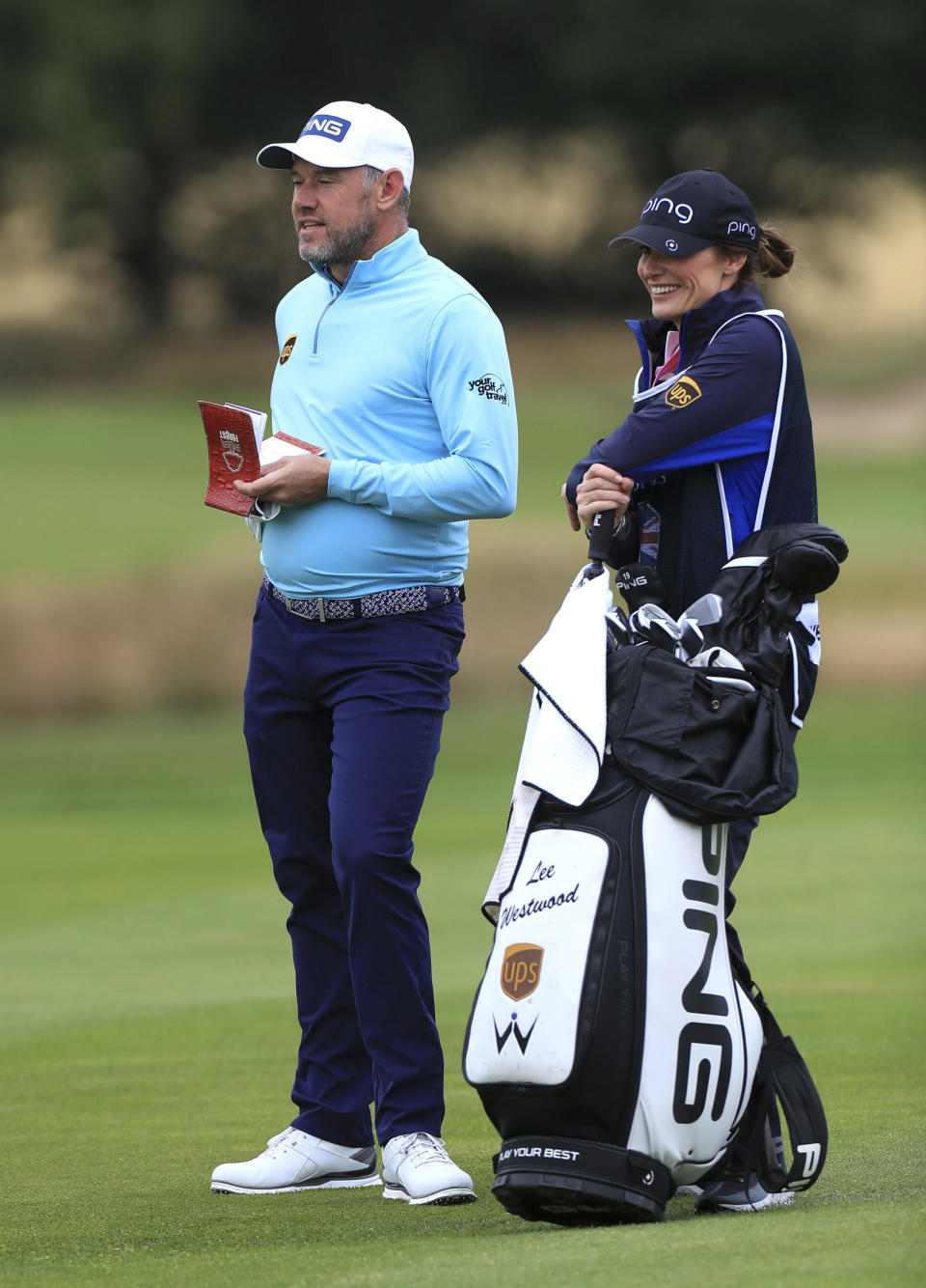 England's Lee Westwood with his girlfriend and caddie Helen Storey on the 3rd during day one of the British Masters at Close House Golf Club, near Newcastle, England, Wednesday July 22, 2020. The European Tour resumes in earnest after its pandemic-induced shutdown with the British Masters starting Wednesday. (Mike Egerton/PA via AP)