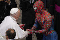 Pope Francis meets Spider-Man, who presents him with his mask, at the end of his weekly general audience with a limited number of faithful in the San Damaso Courtyard at the Vatican, Wednesday, June 23, 2021. The masked man works with sick children in hospitals. (AP Photo/Andrew Medichini)