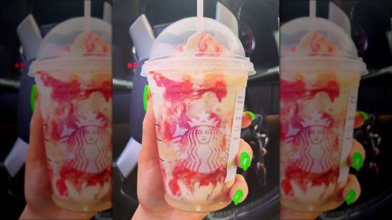 holding strawberry funnel cake frappuccino