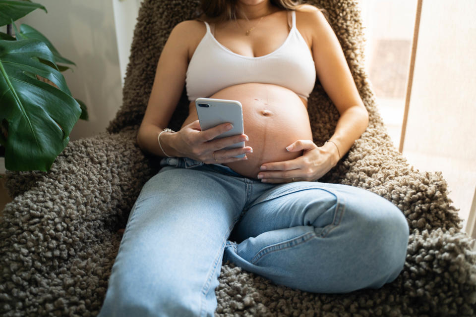 a pregnant woman in a chair with her belly exposed