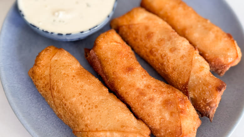 egg rolls with blue cheese sauce on plate