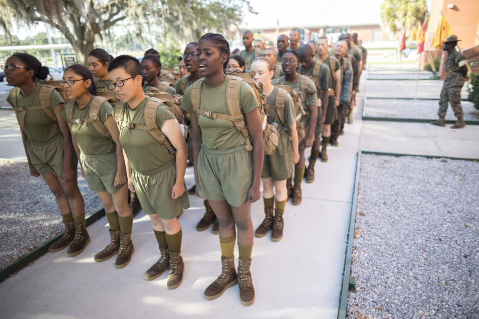 A detail of female U.S. Marine Corps recruits stand in platoon order outside the Marine Corps Recruit Depot pool after swim training, Wednesday, June 28, 2023, in Parris Island, S.C. (AP Photo/Stephen B. Morton)