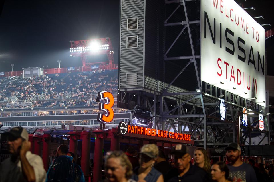 Fans leave the stadium after hearing the Garth Brooks concert has been postponed due to weather at Nissan Stadium in Nashville, Tenn., Saturday, July 31, 2021.