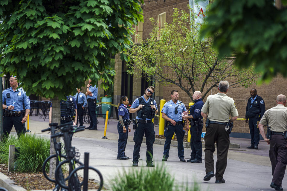 Police officers investigate a fatality in an officer involved shooting, Thursday, June 3, 2021 in Minneapolis. One person was killed Thursday when authorities who were part of a task force that included U.S. Marshals fired their weapons after the person displayed a handgun in Minneapolis' Uptown neighborhood, the U.S. Marshals said. (Richard Tsong-Taatarii/Star Tribune via AP)
