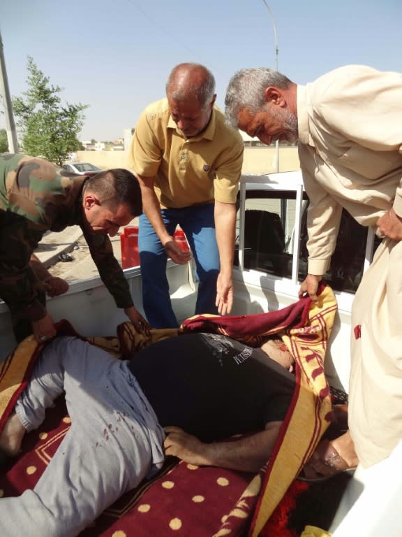 The body of an Iraqi policeman, who was reportedly killed at his house by jihadist gunmen, lies in the back of a pick-up truck in the southern suburbs of Kirkuk on October 22, 2016