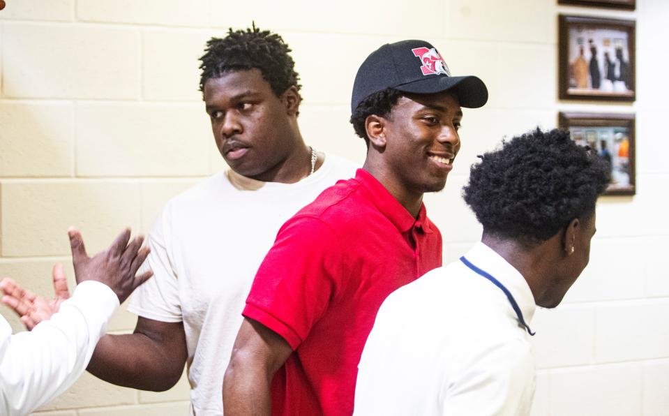 From left, Dunbar High School football players Jonathon Cole, Jeremiah Livingston and Deondrick McCutcheon attend  a signing day at the school on Tuesday, April 19, 2022. Cole signed with McDougle Technical Institute. Livingston signed with Muskingam University and McCutcheon signed with  McDougle Technical Institute. 