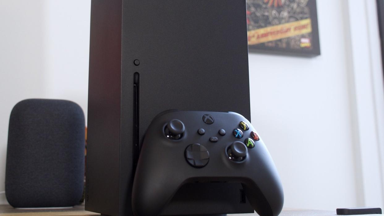  Xbox Series X console with controller on desk. 