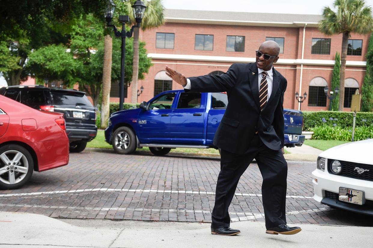Indicted Augusta Commissioner Sammie Sias waves to members of the media as he walks to the U.S. District Court for Southern District of Georgia courthouse in Augusta before his pretrial conference on Thursday, July 14, 2022. Sias was indicted for interfering with an FBI investigation. 