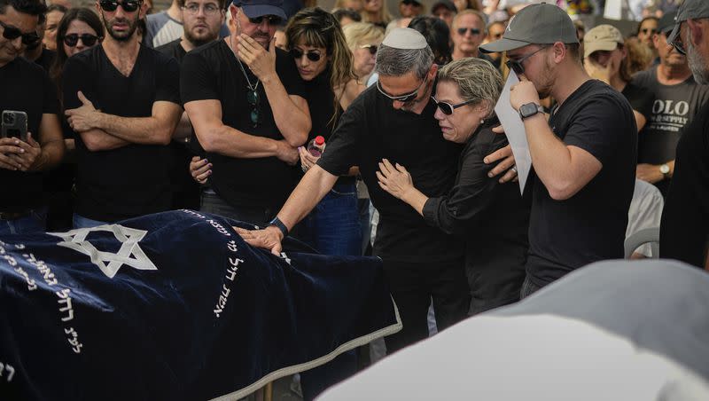 Mourners gather in grief around the bodies of Danielle Waldmann and her partner Noam Shai during their funeral in the northern Israeli town of Kiryat Tivon Thursday, Oct. 12, 2023. The couple was killed when Hamas militants went on a brutal rampage through southern Israel last Saturday, part of an unprecedented, multi-front attack on the country.