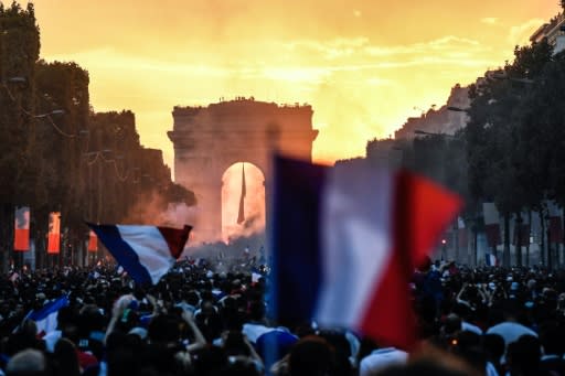 People in Paris celebrate France's World Cup win