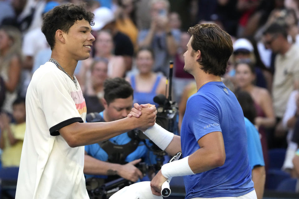 Ben Shelton, left, of the U.S. is congratulated by compatriot J.J. Wolf following their fourth round match at the Australian Open tennis championship in Melbourne, Australia, Monday, Jan. 23, 2023. (AP Photo/Ng Han Guan)