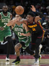 Atlanta Hawks guard Trent Forrest (2) and Boston Celtics forward Jayson Tatum (0) chase down a loose ball during the second half of an NBA basketball game Thursday, March 28, 2024, in Atlanta. (AP Photo/John Bazemore)