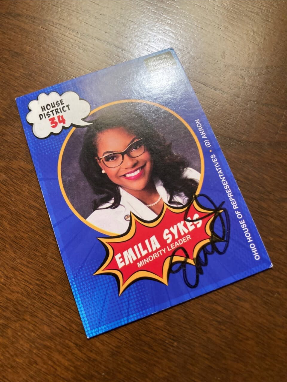 A trading card of Ohio House Minority Leader Emilia Sykes is photographed at Ohio House legislative aide Adam Headlee's office in the Riffe Center in Columbus, Ohio, on Friday, Dec. 17, 2021. Sykes, an Akron Democrat, was the final state representative to provide her autograph to complete Headlee’s collection of signed trading cards. Headlee said the good humor with which both Republicans and Democrats greeted his project sends “a subtle message of unity” at a politically divided time. (AP Photo/Julie Carr Smyth)