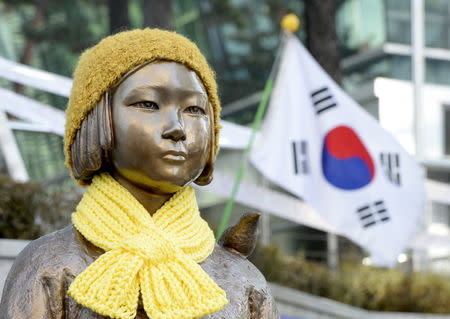 A statue of a girl that represents the sexual victims by the Japanese military is seen in front of Japanese embassy in Seoul, South Korea, December 28, 2015. REUTERS/Ahn Eun-na/News1