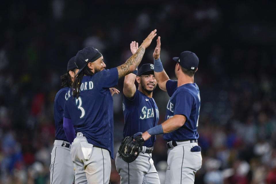 Seattle Mariners, including J.P Crawford, front left, celebrate a win against the Los Angeles Angels in a baseball game Thursday, Aug. 3, 2023, in Anaheim, Calif. (AP Photo/Ryan Sun)