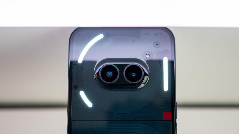 The camera island on the back of the Nothing Phone (2a) with the glyph lights illuminated