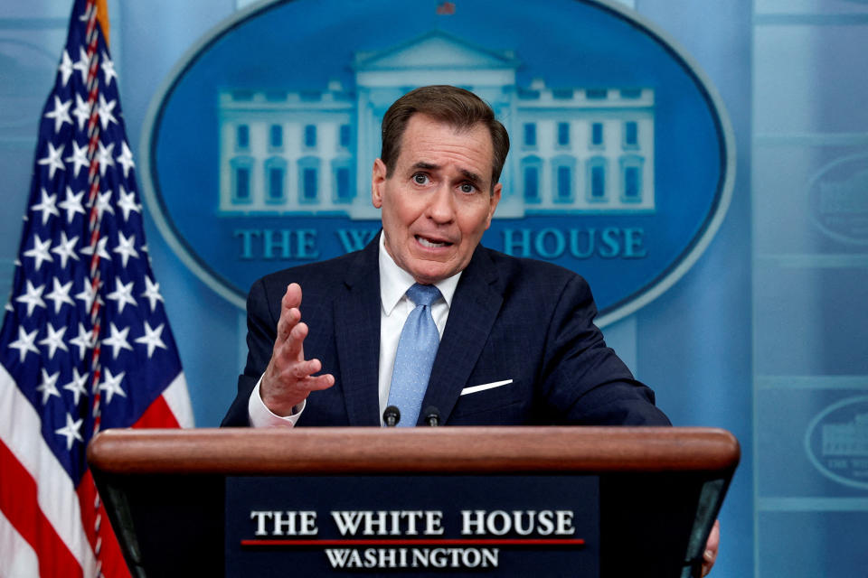 Pentagon spokesman John Kirby stands at a podium as he answers questions at a press briefing.