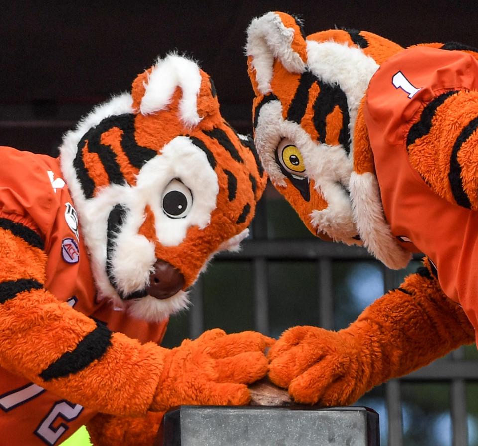 The Tiger Cub, left, and the Tiger mascots rub Howard's Rock before the game at Memorial Stadium before the game with Florida State in Clemson, South Carolina Saturday, October 12, 2019. 